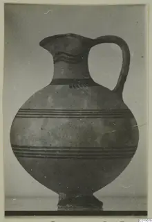 White Painted I jug from Lapithos, photographed against a plain grey background