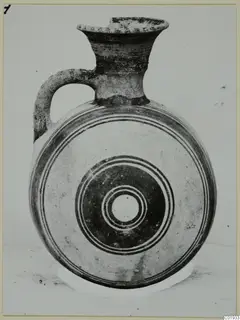 White Painted II jug from the Kastros tombs at Lapithos, with a flattened disc-shaped body and concentric painted circles