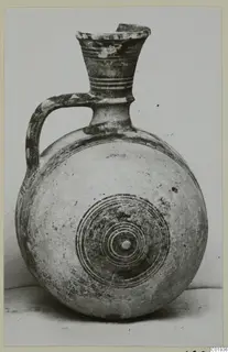 Pottery Bichrome II jug from Lapithos, with a round body and concentric circles painted on its front