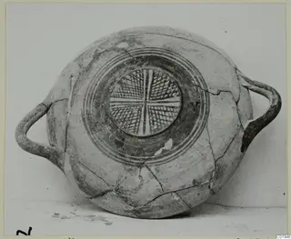 Pottery White Painted I bowl with two side handles and a cross-hatched central medallion surrounded by concentric rings
