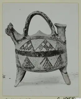 Pottery White Painted I jug from Lapithos, with strap handle, three legs and dark painted triangles and bands