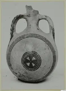 Two-handled White Painted II pottery flask with concentric bands and a central star-shaped motif on its body