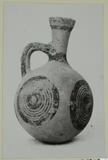 Small jug with a flaring neck, loop handle and dark concentric circles on its body, from the Kastros tombs at Lapithos