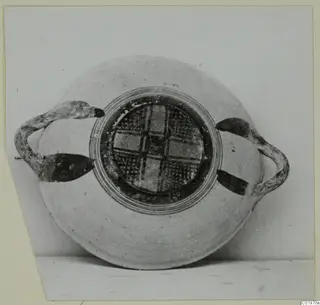 White Painted I bowl with two side handles, photographed against a plain grey background, from Lapithos Kastros tombs