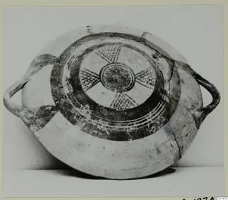 White Painted I bowl with two handles and painted interior of radiating cross-hatched bands around a central circle