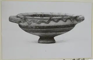 White Painted I bowl from Lapithos with two horizontal handles, a ring foot and a wavy painted band around the body.