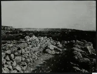 Rough stone walls running along a path toward a low hill ridge at Nitovikla on the Karpas Peninsula