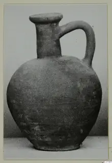 Pottery Plain White I-III jug with a round body, tall narrow neck and single loop handle