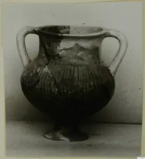 Pottery Black Slip Ware pot with two handles, a ribbed body and a small foot, from Lapithos