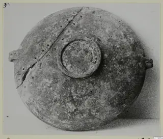Foreign Red Slip vessel seen from above, with a central circular boss and two small handles on opposite sides