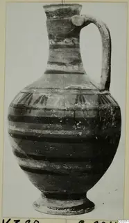 Jug from Vouni with a strap handle, a flared neck and dark painted bands on the body