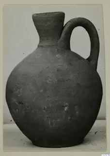 Jug of Plain White VII ware from Vouni, with a single loop handle and narrow flaring neck