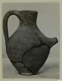 Pottery Plain White VII, a feeding bottle with a single handle and a spout, with a repaired crack.