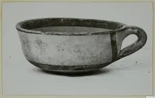 White Painted IV bowl with a loop handle, from Marion
