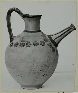 Pottery White Painted III-1 jug with a side spout and a row of concentric circles around the shoulder