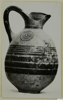 Black-on-Red II-IV jug with a strap handle, dark painted bands and a concentric circle motif