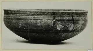 Pottery bowl of Black-on-Red ware, shown from the side against a pale background