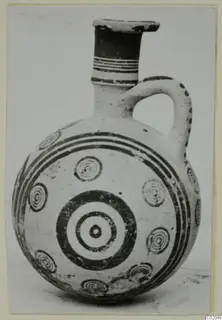 Jug with a round body, banded neck and concentric circle motifs in dark paint, from Marion, Pottery Black-on-Red I-III