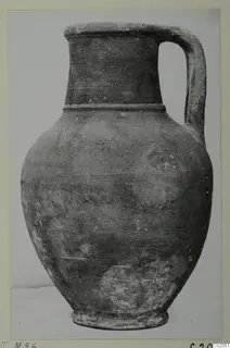 Single-handled jug with a tall neck and rounded body, photographed against a pale background.