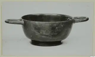 Two-handled black glazed bowl with a ring foot, from Marion, shown in side view