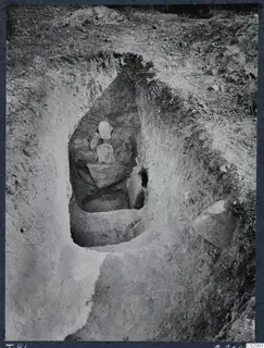 Excavated cut at Marion with large stones inside and grass growing on the ground above it