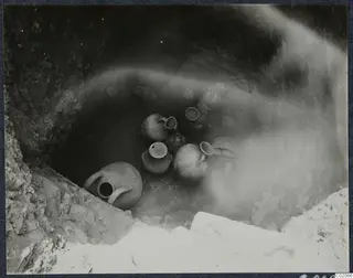 Pottery vessels in situ at the bottom of Tomb 80 at Marion during excavation