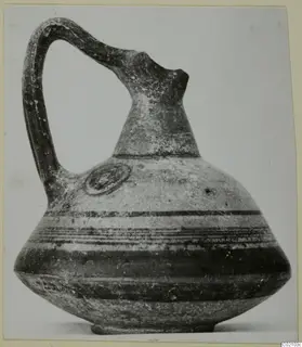 Pottery Black-on-Red II-IV jug with a tall neck, strap handle and horizontal dark bands on the body