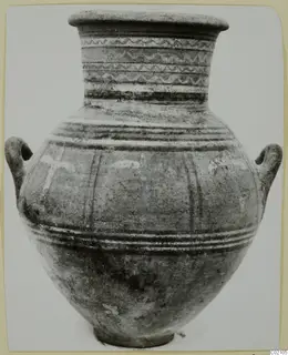 Two-handled pottery jar with banded and wavy painted decoration on its neck and body