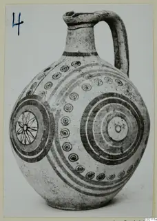 Pottery Bichrome IV jug with concentric circles, dotted rings and a star motif, photographed on a card mount