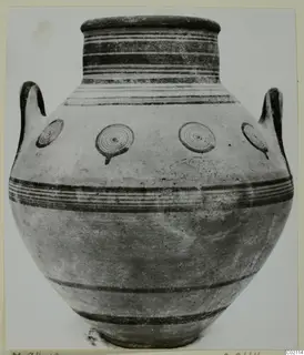 Two-handled jar with dark horizontal bands and concentric circle motifs on its body