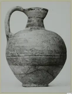 Pottery Bichrome V jug with a strap handle and horizontal painted bands, shown against a plain background