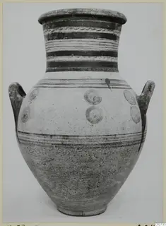 Large two-handled pottery jar with white slip, horizontal dark bands and concentric circle motifs.