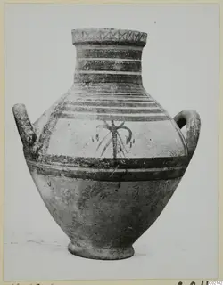 Two-handled pottery vessel with painted bands and a dark central motif, from the Marion tombs 61–98 finds