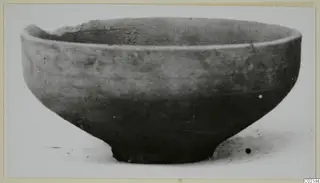 Pottery bowl from Marion, Plain White IV-V, with a broken rim at the upper left