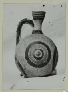 White Painted I jug with concentric circles on its body, photographed on a card mount