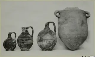 Four pottery vessels from Marion, Tomb 81 A, arranged in a row by size, from a small juglet to a large two-handled jar.