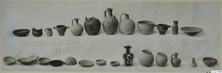 Two rows of pottery vessels on a white cloth, including jugs, cups, jars and shallow bowls