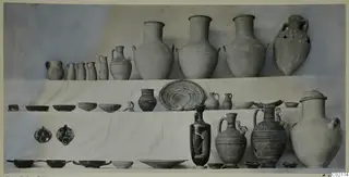 Pottery vessels from Tomb 41 at Marion, jars, jugs, bowls and plates arranged in tiers on white cloth