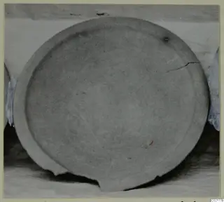 Plain White VI pottery vessel, a shallow circular dish seen from above, with a crack and chipped rim