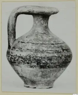 Pottery jug with a strap handle and dark painted bands, from tombs 61–98 at Marion