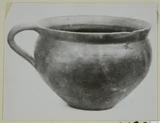 Handled pottery vessel with a wide mouth and rounded body, shown against a plain white background.
