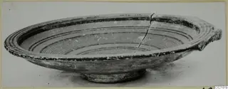 Pottery Black-on-Red II-IV bowl with concentric bands inside and a small projection at one side
