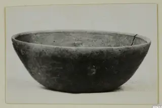 Pottery bowl with a rounded body and everted rim, photographed from the side