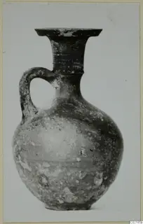 Jug with a single loop handle, a flared rim and a rounded body, shown against a plain light background