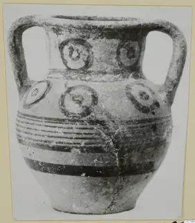 Two-handled pottery vessel from Marion with circular motifs and horizontal dark bands
