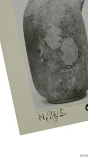 Lower body and ring base of a plain pale pottery vessel, shown as a mounted photograph