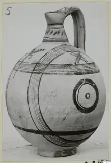Pottery vessel, White Painted V: a globular jug with a strap handle and dark painted bands and concentric circles