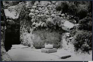 Trench 1 at Loures with a cement floor and a column base in situ against a stone wall
