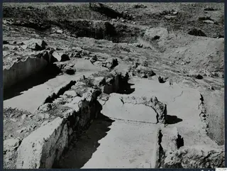 Excavation trenches with exposed stone walls and flat floor surfaces at the palace at Vouni.