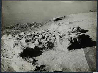 Collapsed stone walls of the palace at Vouni on a bare headland above the sea